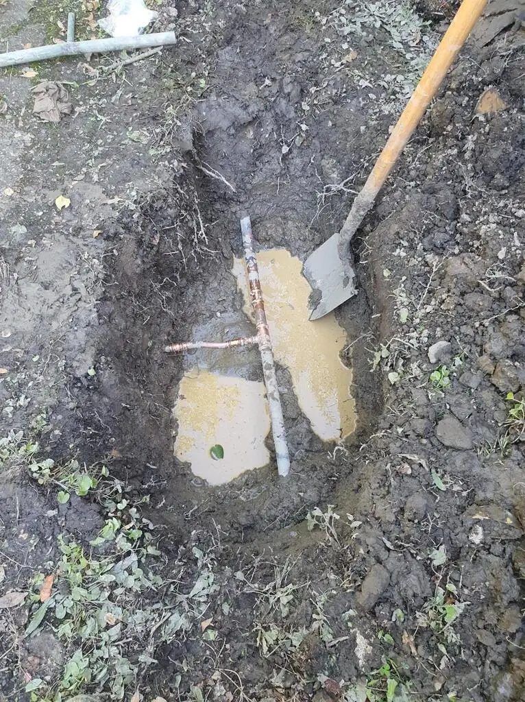 Burst water pipe repair in progress.